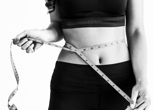 A woman who went through significant change in her waist length after a weight loss treatment.