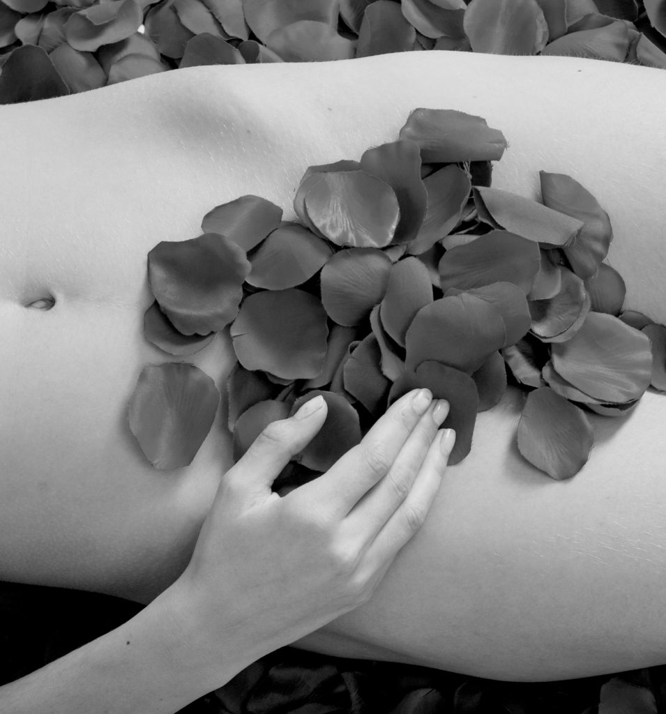 Rose petals covering a woman's vaginal area